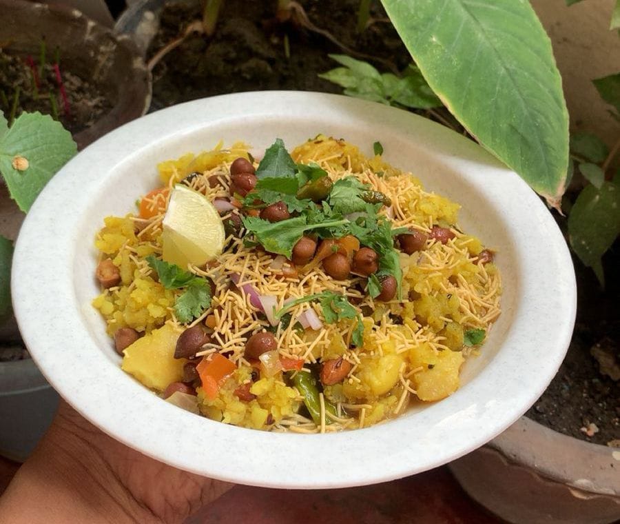 Delicious Chana Poha served with sev and lemon slice